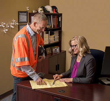 Photograph of going over plans in office.