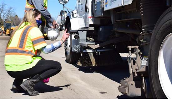 Photograph of Commissioner Pickering at sweeper truck