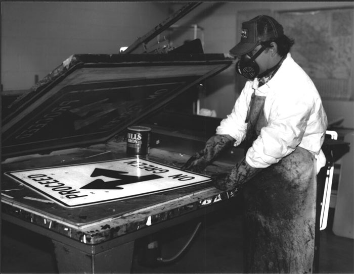 Black and white photograph of Ron Spurl in sign shop in jpg