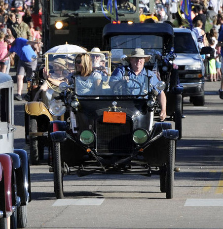 Photograph of antique cars in parade